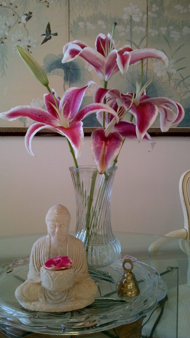 A vase with flowers in it sitting on top of a table.