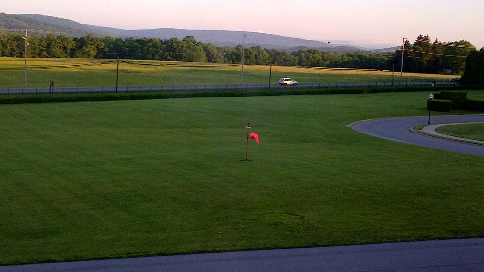 A red flag is in the middle of a field.