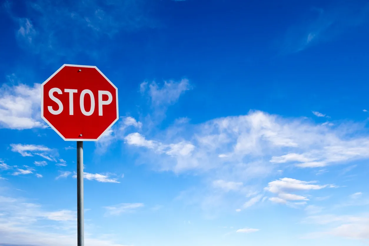 A red stop sign sitting on top of a pole.