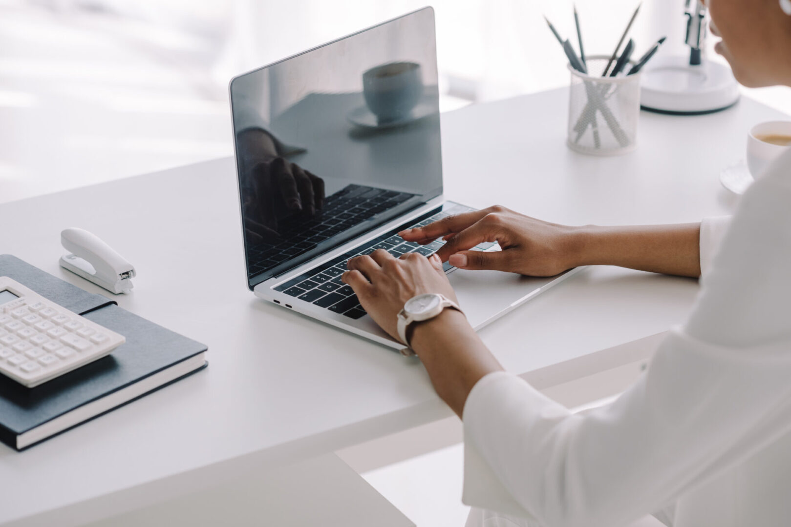 A person is using their laptop on the table