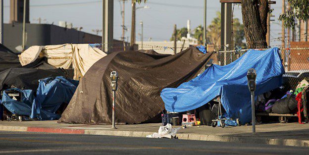 A tent is set up on the side of the road.